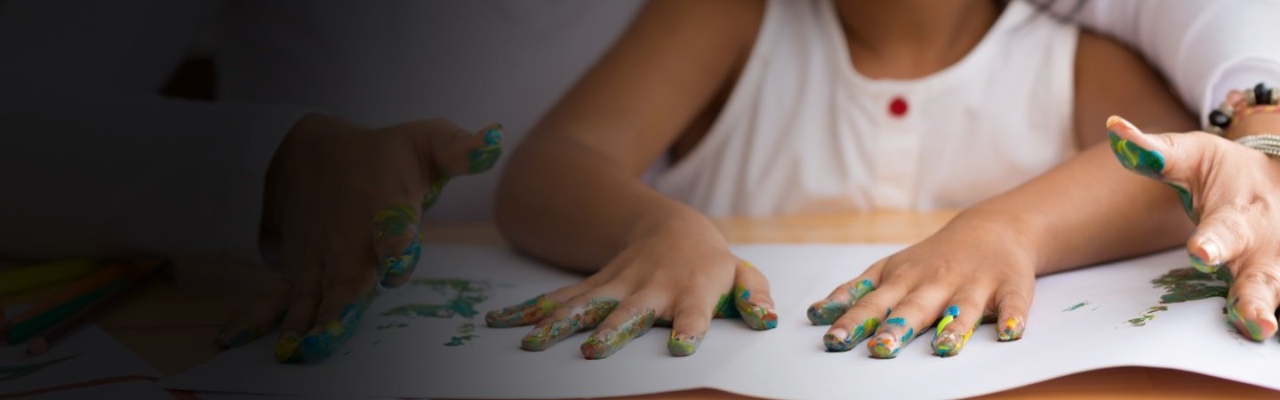 Cropped image of mother and daughter doing fingerprints, selective focus